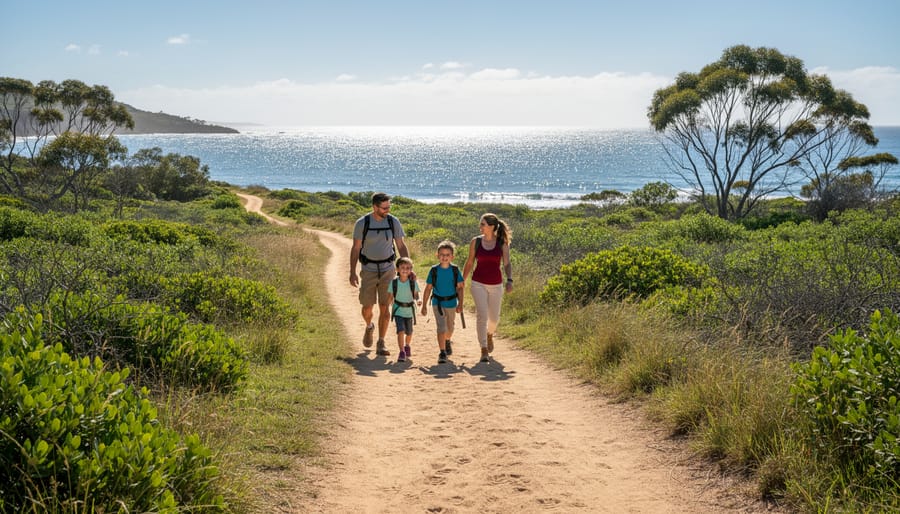 Adult and child hiking on Middlebrun Bay Trail toward a bay view
